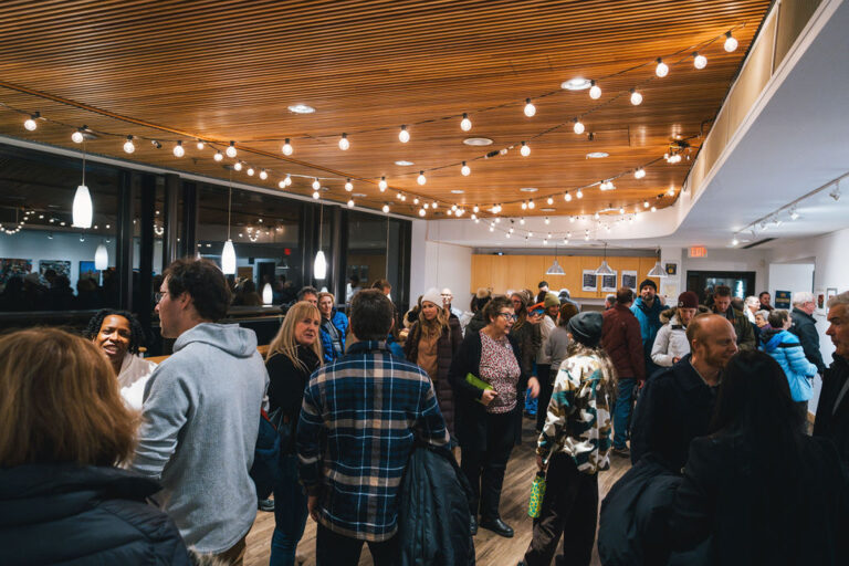 Attendees mingle in the Gallery before the talk